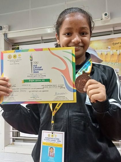 Harini with her bronze medal from the mini Olympic Games, an event organized by the Karnataka Olympic Association.