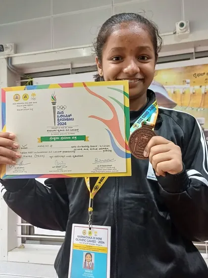Harini with her bronze medal and certificate from the Mini Olympic Games. Every competition is a valuable learning experience on the path to becoming a seasoned shooter.