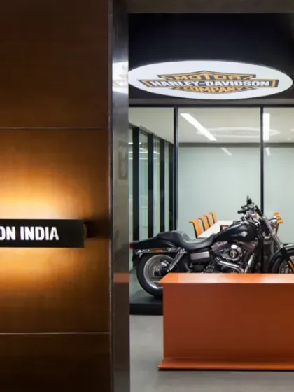 The entrance to the Harley-Davidson India office immediately immerses visitors in the brand's world. A signature motorcycle is displayed prominently in a glass-enclosed meeting room, making a bold statement about the company's passion and heritage.