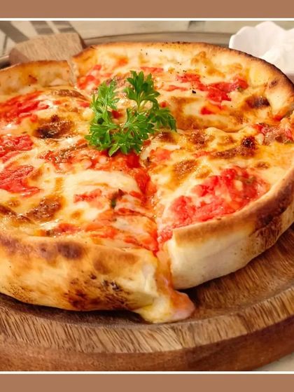 Another look at our deep-dish Chicago-style pizza. The thick, buttery crust holds a generous amount of sauce, cheese, and toppings for a hearty meal.