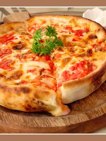 Another look at our deep-dish Chicago-style pizza. The thick, buttery crust holds a generous amount of sauce, cheese, and toppings for a hearty meal.