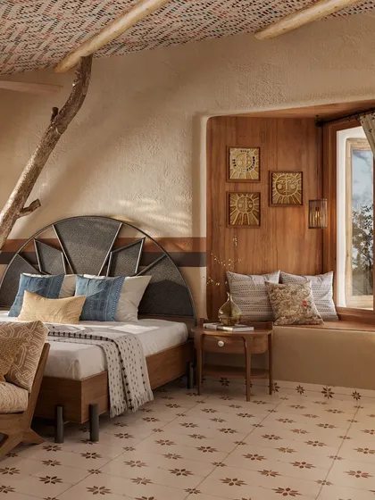 A cozy window seat provides the perfect nook for reading or enjoying a morning cup of tea. The mix of patterned cushions and the warm wood of the window frame create a comfortable and inviting corner.