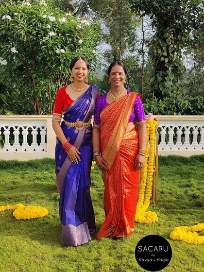 A mother-daughter duo, both looking elegant in their custom Sacaru blouses and traditional Kanjeevaram sarees.