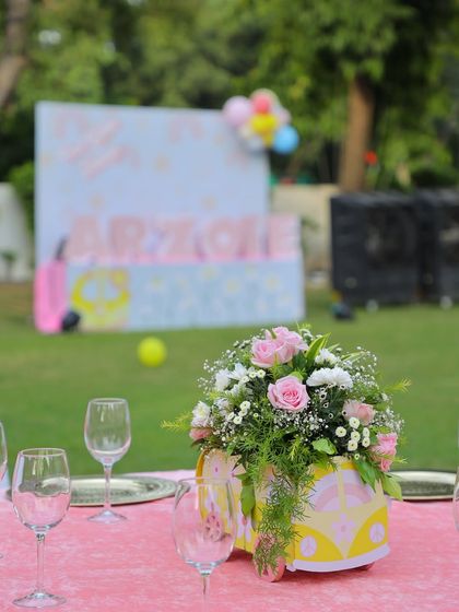 Another view of the wagon centerpiece, with the main party backdrop visible in the distance. This shows how the theme is consistently applied across all elements of the event.