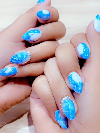 Blue marble nails designed for a client's Goa trip, complete with a sparkling rhinestone accent on the ring finger.