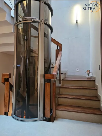 Design that moves you, both literally and aesthetically. For this villa, we integrated a sleek, all-glass vacuum elevator into the stairwell, pairing it with Indonesian walnut treads and an architectural concrete wall. It’s a statement of how we merge innovative technology with timeless materials for luxury and comfort.