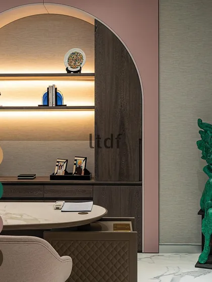 Celebrating colors in design. In this office, a bold green sculpture provides a vibrant contrast to the soft, dusty pink of the arched niche, demonstrating how color can be used to create focal points and express personality.