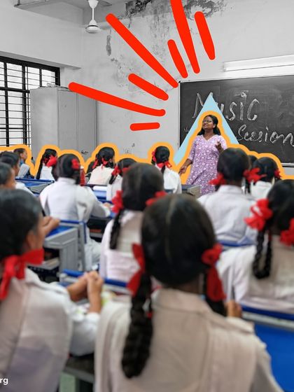 A classroom of girls with matching red ribbons listens intently as their instructor leads a music session. The image captures the discipline and focus that music helps to cultivate.