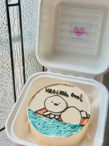 A cute and simple bento cake with a minimalist character design. Perfect for celebrating a little one or just sending a sweet message.