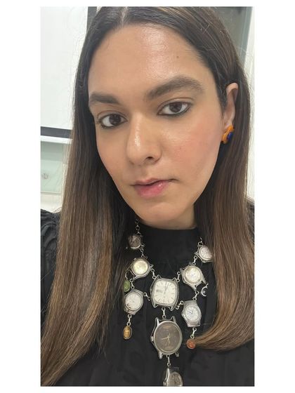 I never met a quirky accessory I didn’t like. This selfie shows off a statement necklace made of vintage watch faces, a truly unique piece that reflects my personal style.
