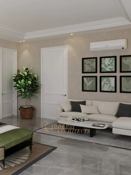 The room includes a comfortable sofa and botanical artwork, creating a relaxed seating area that complements the bedroom's earthy and elegant theme.