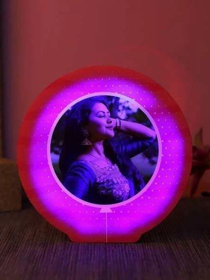 A modern, circular photo lamp that provides a vibrant glow. Your photo is placed in the center, illuminated by a ring of colorful LED light, creating a stylish desk accessory.