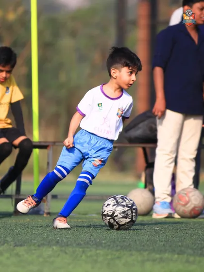 A young athlete focused on the ball, ready to make a play. This is the concentration we instill in our training.