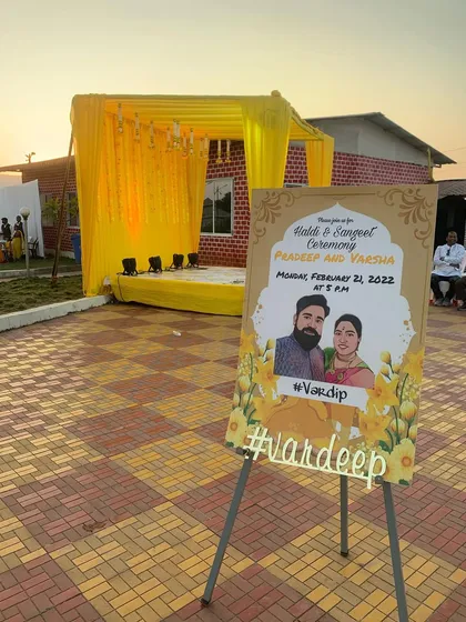 For this Haldi and Sangeet ceremony, I created a simple yellow draped stage and a personalized welcome sign for the couple, adding a lovely custom touch to the event entrance.
