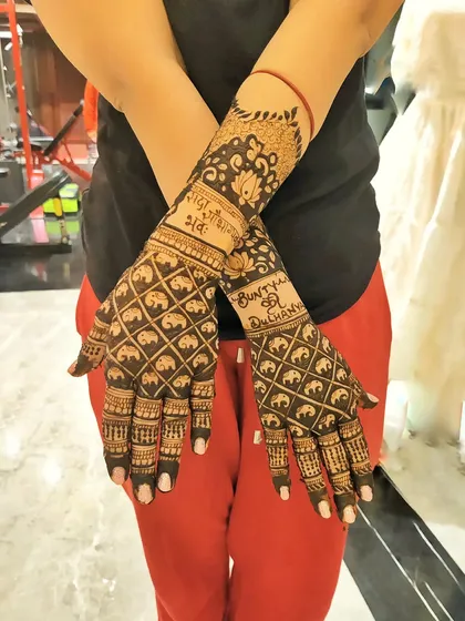 A full-arm design featuring a repeating pattern of mini elephants. This style creates a rich, textured look that is both traditional and modern, with space for personalized text on the wrists.