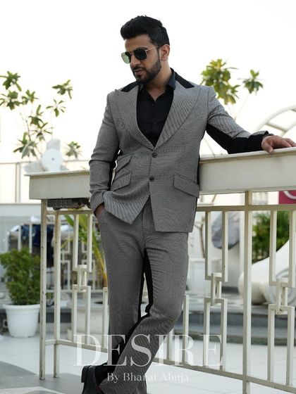 This grey and black color-blocked suit is all about sharp lines and modern sophistication. I designed it to create a powerful silhouette that stands out in any professional or formal setting.