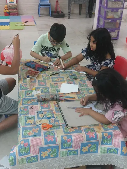 Kids engrossed in their world tour art project. They are learning about different cultures and landmarks while practicing their drawing and coloring skills.