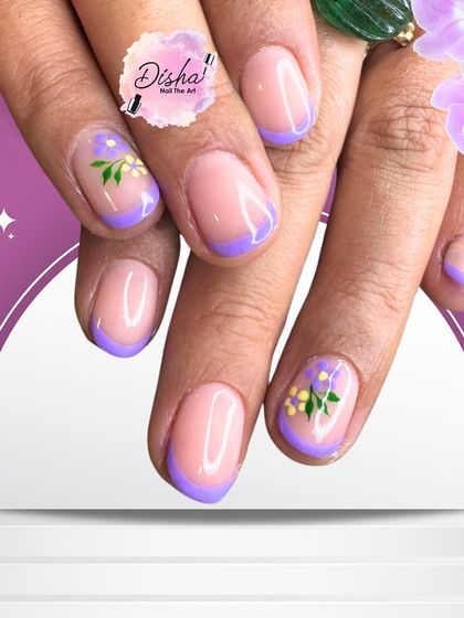 Lavender tips complementing pink nails. A colorful twist on the classic French, this design also features tiny, hand-painted floral details.