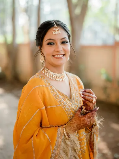 A close-up portrait of this lovely bride. Her skin looks fresh and dewy, and the makeup is kept subtle to highlight her natural features.