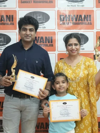 An adult student and her daughter, both winners, with their trophies.