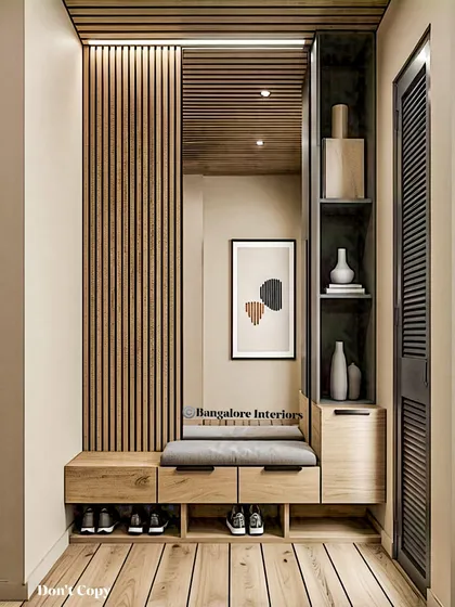An entryway should be both welcoming and practical. This unit features a comfortable seating bench, open shoe storage for daily use, and drawers for clutter-free living, all tied together with elegant wood fluting and a full-length mirror.