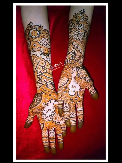 A gorgeous floral engagement design with the couple's initials subtly placed in the center of the palms. The patterns are intricate and flowing.