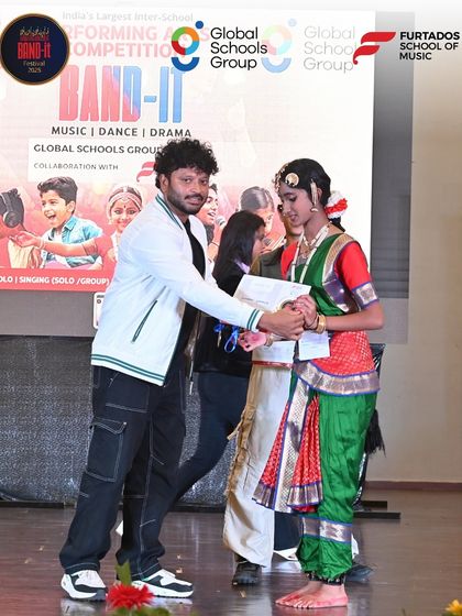 A winner of the classical dance category at the Bangalore Band-It competition receives her award. This image celebrates the traditional arts and the dedication of our young performers.