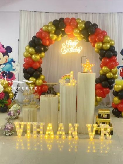 A timeless classic, this Mickey and Minnie Mouse theme is perfect for any age. The setup includes a full balloon arch in the iconic red, black, and gold colors, character cutouts, and illuminated marquee letters for the name.