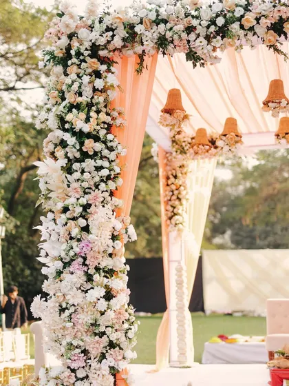 A detailed shot of the floral pillars of the mandap. I use an abundance of fresh flowers to create these lush, romantic structures that frame the couple beautifully.
