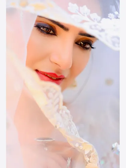 A soft and intimate beauty shot, using a delicate veil to frame the face. This style of portraiture is perfect for capturing a sense of grace and elegance in beauty or bridal portfolios.