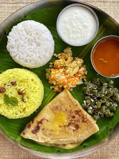 A classic Ugadi festival meal. Festivals are for enjoying guilt-free with family. One high-calorie meal like this plate with obbattu, lemon rice, and other traditional dishes will not derail your progress.