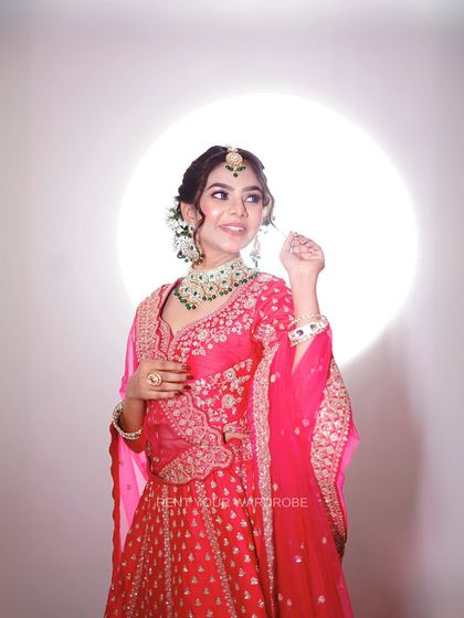 A close-up on the details. The intricate blouse work and the stunning emerald necklace are perfect for capturing high-end portfolio shots.