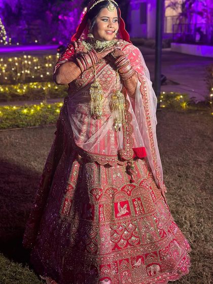 A full-length shot of the bride in an outdoor setting, showing how the makeup looks beautiful in any lighting.