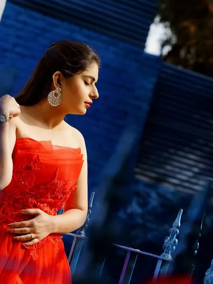 A beautifully composed portrait of the bride-to-be. The lighting and angle highlight her elegant pose and the vibrant color of her dress.
