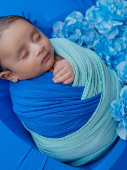 A heart of blue. This simple and sweet setup places the swaddled baby inside a blue heart, surrounded by matching flowers.