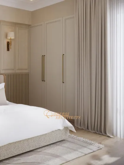 A view of the seamless, floor-to-ceiling wardrobes with long, elegant handles, which provide ample storage while maintaining the room's clean and serene aesthetic.