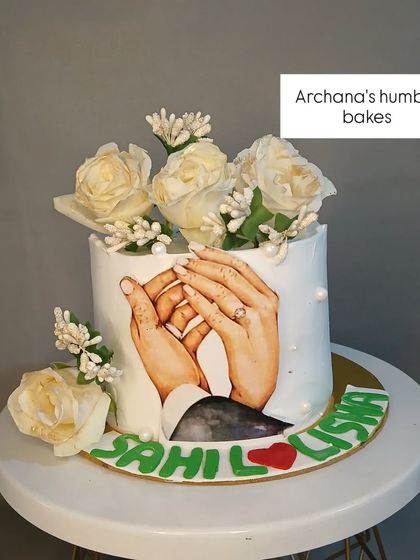 A single-tier version of the "holding hands" engagement cake, this time with elegant white roses.