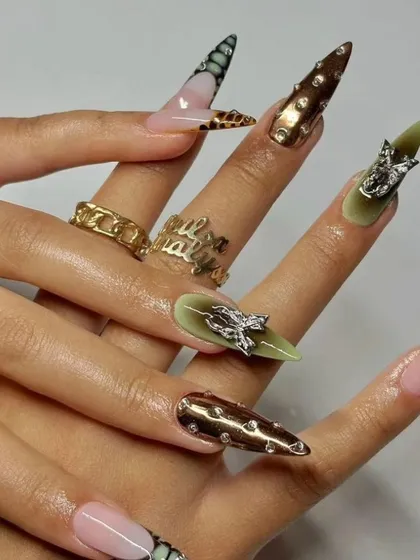 This high-fashion set combines multiple techniques, including metallic chrome, animal print, and bold 3D silver charms. These extra-long stiletto nails are designed for making a powerful statement.