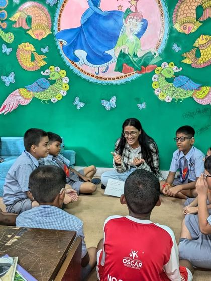 A volunteer leads an interactive discussion at our East Meets West Library. We believe stories are a starting point for conversations that build empathy and understanding.