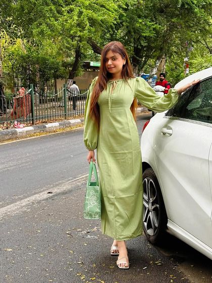 A full-length view of the green dress, showing its flattering silhouette.