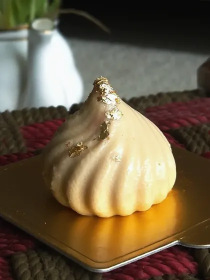 A detailed look at my Cheesecake Modak. The smooth, glossy finish and delicate gold leaf make this a truly elegant and unique festive dessert.