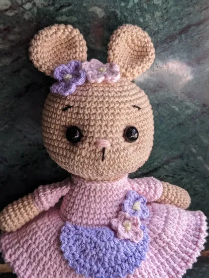 A close-up of the bunny doll with floral details.