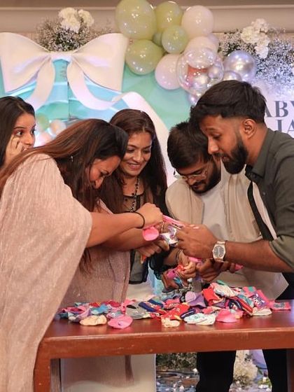 Guests working together on a fun game at the baby shower. These activities are a great way to break the ice and encourage interaction among family and friends.