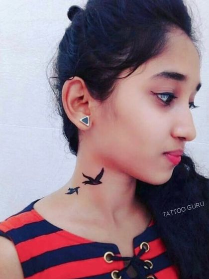 Two small birds tattooed on the side of the neck.