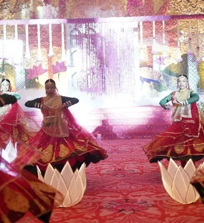 We love using unique props to enhance an entry. For this traditional Varmala, dancers used illuminated lotus props while performing, adding a beautiful, symbolic layer to the bride's entrance.