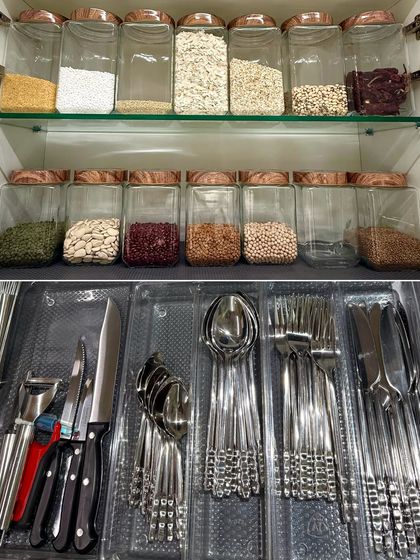 A look at two core parts of our service: a perfectly organized cutlery drawer and a well-stocked pantry cabinet with decanted grains.
