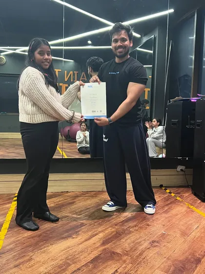 Presenting another certificate to a dedicated dancer. Our goal is to build a strong, supportive community that celebrates every achievement, big or small.