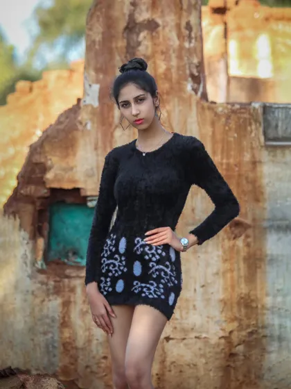 A three-quarter shot that focuses on the details of the patterned skirt and the model's direct gaze.