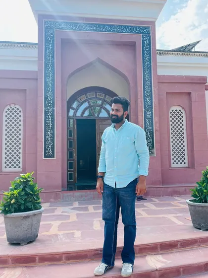 Standing before a beautiful mosque, the sun casting a glow. I am always ready to serve my motherland, even if it demands the ultimate sacrifice.