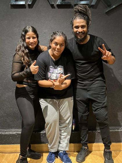 A student posing with our guest instructors, celebrating a great class.